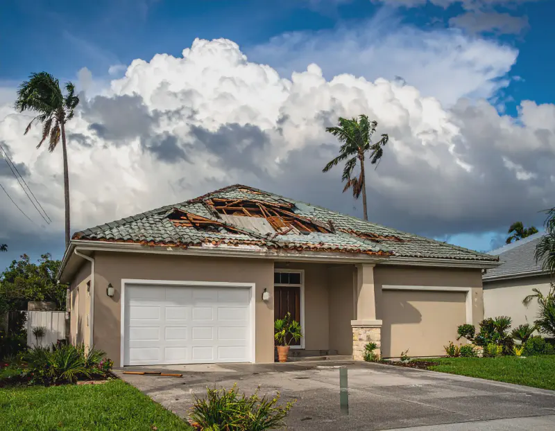 Storm-damaged roof with exposed decking in Parrish, FL